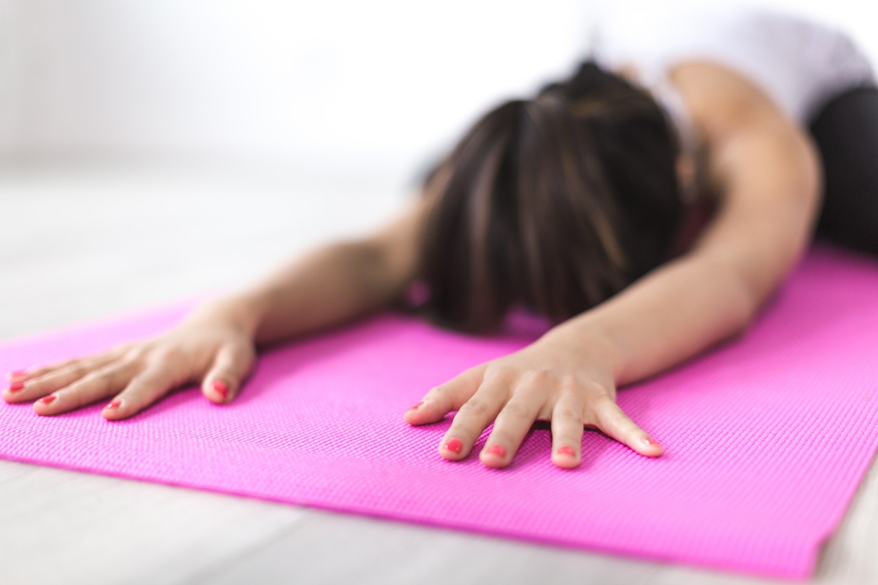 Practice yoga to find your inner zen Woman exercising on yoga mat