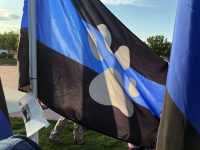 Black paw print flag with blue stripe