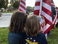 Young girls surrounded by American flags