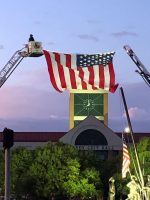 Huge flag hanging off two ladders