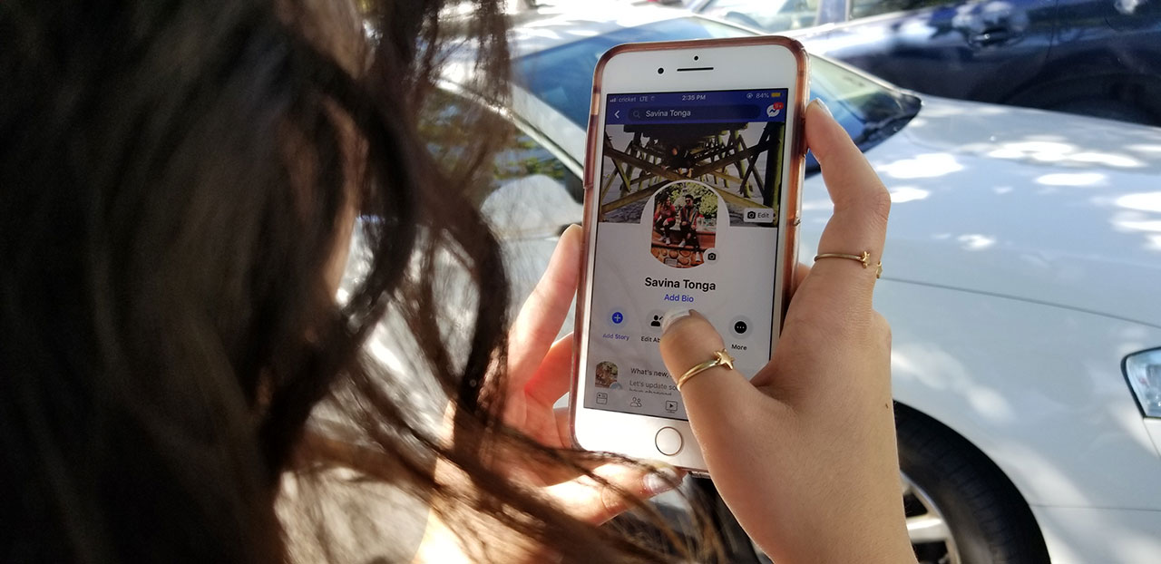 Think before posting, how social media can affect job prospects woman scrolling through Faceook