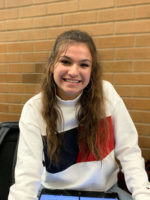 Delaney smiles while studying