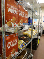 Pantry rack full of cereal, potatoes and noodles