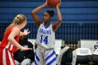Aminata Diakite holds the ball over her head
