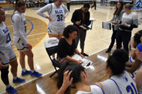 Players gather around Coach Grayer
