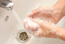 Stay germ-free this flu season Woman washing hands under running water