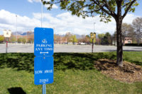 Old parking signs in front of empty lot