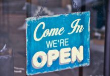 SLCC students express concern over reopening economy "Come In We're Open" sign