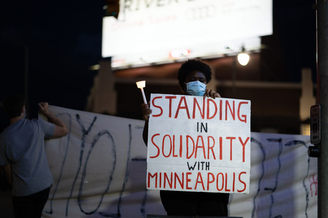 Sign reads "Standing in solidarity with Minneapolis"