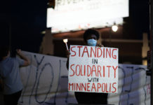Marching forward: Chauvin conviction eases unrest Sign reads "Standing in solidarity with Minneapolis"