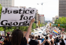 2020: A year in review Sign reads "Justice for George"