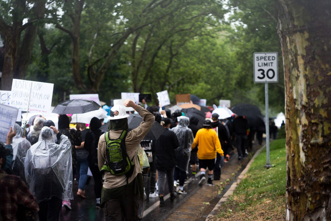 Rain-soaked protesters march in solidarity