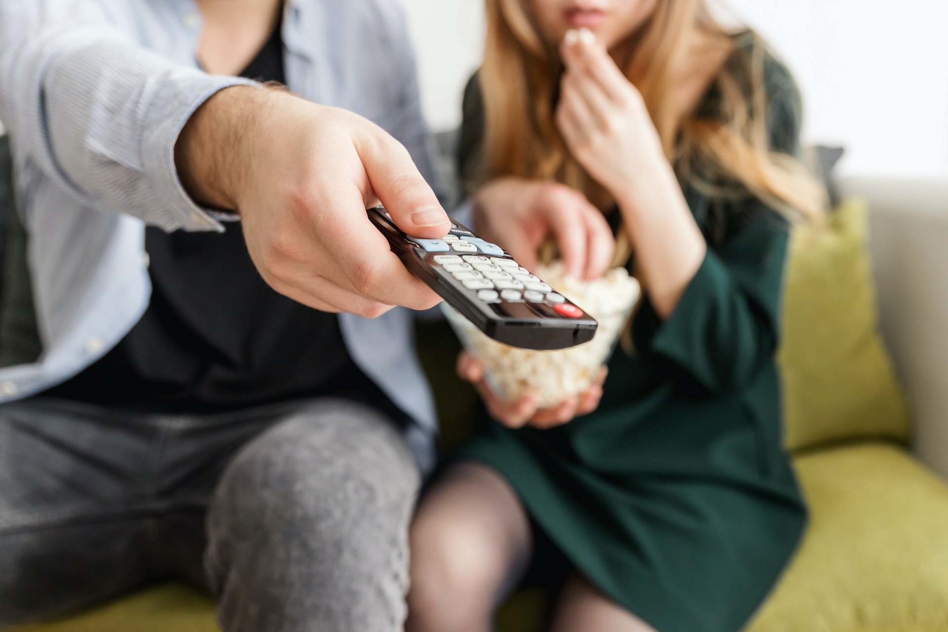 4 Hulu originals to stream this summer Man holding remote control