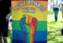Love always wins: Pride, BLM unite in fight for equality Sign reads "Love always wins"