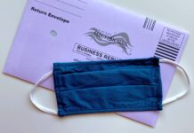 Voting in light of COVID-19 American election mail envelope with face mask
