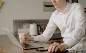 Online classes become new normal; pants optional Man in white dress shirt using Macbook Pro