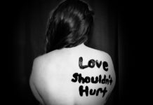 Domestic violence cases spike during pandemic "Love shouldn't hurt" painted on woman's back