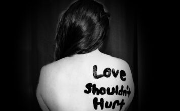 Domestic violence cases spike during pandemic "Love shouldn't hurt" painted on woman's back