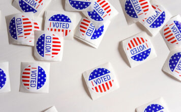 2020 election survey: Respondents prioritize climate change, race, ethnic inequality Stickers with "I voted" inscription and flag of USA