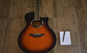 Songwriting workshop teaches students to express themselves Blank notepad lying next to guitar