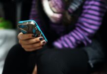 Missing: The art of conversation Woman holding blue smartphone