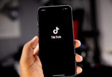 TikTok leaves an impression, but not all SLCC students want the app Person holding iPhone loading TikTok app