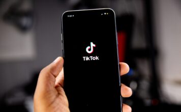 TikTok leaves an impression, but not all SLCC students want the app Person holding iPhone loading TikTok app