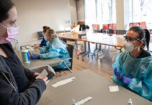 COVID-19 testing available on select campuses Student talking to nurse