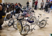 SLCC professor sparks change in the community Row of bicycles on display in auditorium