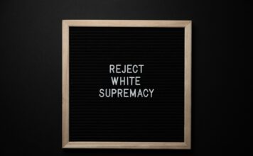 No More Silence: Black Student Union speaks for change Chalkboard reads "reject white supremacy"