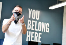 Gender and Sexuality Student Resource Center extends virtual help to lonely students Peter Moosman stands in front of wall that reads "You belong here"