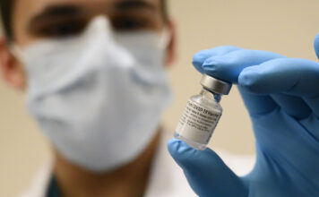 Students react to COVID-19 vaccine rollout Army Spc. Angel Laureano holds a vial of the COVID-19 vaccine