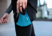 SLCC to continue requiring masks after Utah lifts statewide mandate Person holding teal-colored mask with keys in left hand