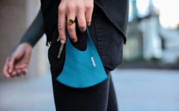 SLCC to continue requiring masks after Utah lifts statewide mandate Person holding teal-colored mask with keys in left hand