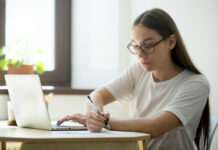 SLCC offers free tutoring resources Serious student working at laptop preparing for exams