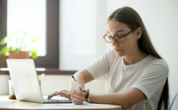 SLCC offers free tutoring resources Serious student working at laptop preparing for exams