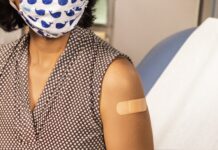 Understanding vaccine hesitancy in Utah’s Latino community Woman wearing bandage after receiving vaccination