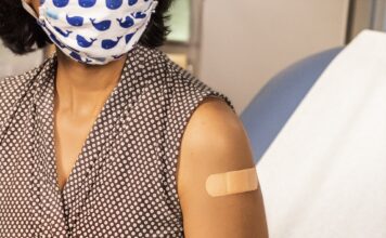 Understanding vaccine hesitancy in Utah’s Latino community Woman wearing bandage after receiving vaccination