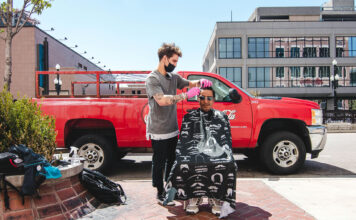 Local barber takes to SLC streets to offer free haircuts Cameron Dean cuts Alex's hair