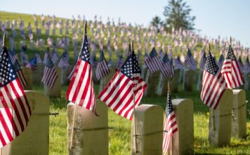 Utah veterans reflect on Memorial Day American flags on cemetery headstones