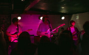 Squid Picnic headlines Kilby Court’s first full-capacity show in 2021 Three band members play guitar in front of live audience