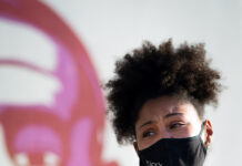 Higher education reacts to CRT debate Rae Duckworth holds a megaphone