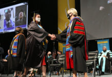 SLCC commencement highlights graduates who overcame challenges of 2020 Graduate shakes hands with college president