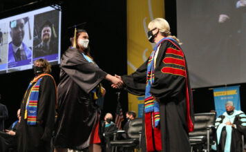 SLCC commencement highlights graduates who overcame challenges of 2020 Graduate shakes hands with college president