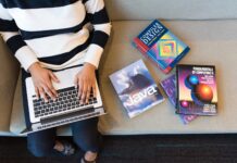 Early exposure to STEM motivates girls in positive ways Woman uses laptop near computer textbooks