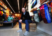 Cotopaxi owner, SLCC alum Davis Smith recognized for making a difference Davis Smith surrounding by Cotopaxi gear