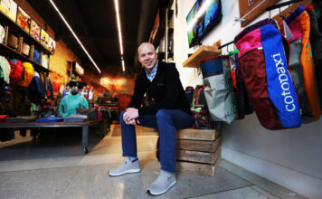 Cotopaxi owner, SLCC alum Davis Smith recognized for making a difference Davis Smith surrounding by Cotopaxi gear