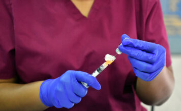 Pfizer-BioNTech COVID vaccine receives FDA approval Nurse prepping vaccine