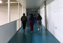 SLCC students remember Lauren McCluskey’s legacy Three students walking on a blue track