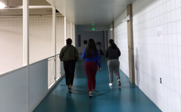 SLCC students remember Lauren McCluskey’s legacy Three students walking on a blue track